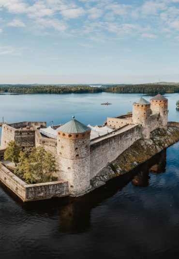 Aerial panorama of Olavinlinna castle and the surrounding lakes in Savonlinna, Finland.